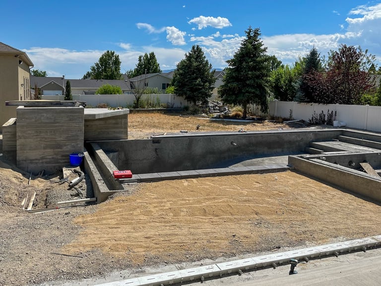 Construction site with concrete foundation walls and framing for a new home building project in a residential area with mountains in background